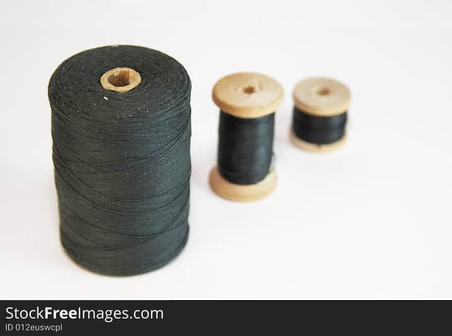 Three coils with black threads. Three coils with black threads