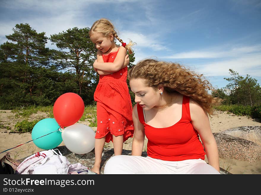 Girls with balloons at the beach