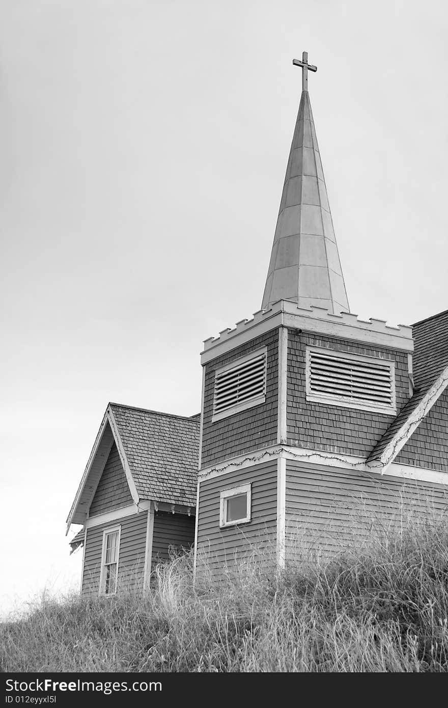 Black and white photo of an old rustic country church sitting on a hilltop. Black and white photo of an old rustic country church sitting on a hilltop