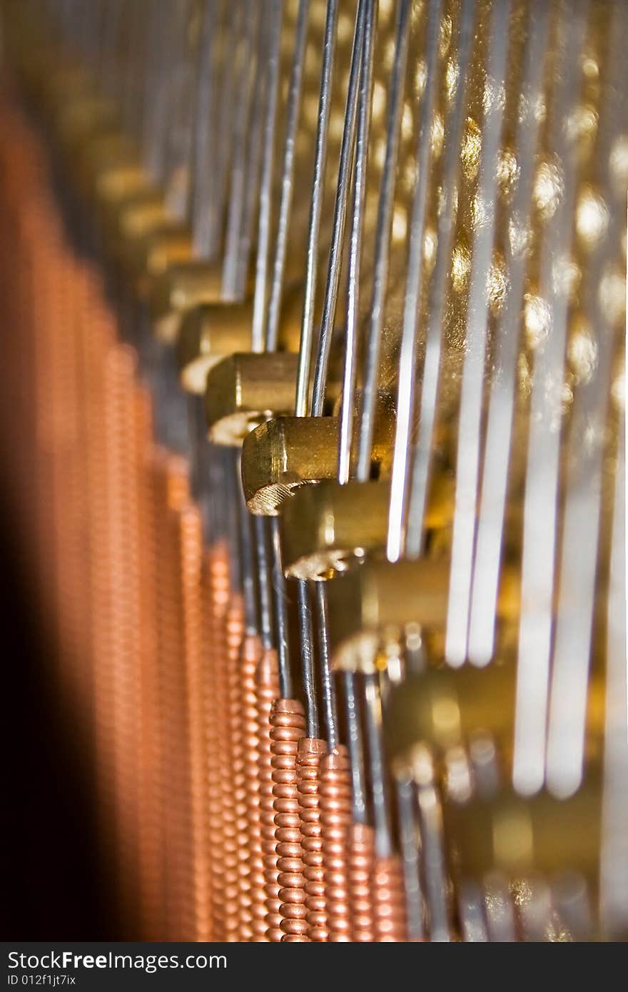 Interior of a piano, wires close-up. Verticalshoot. Interior of a piano, wires close-up. Verticalshoot