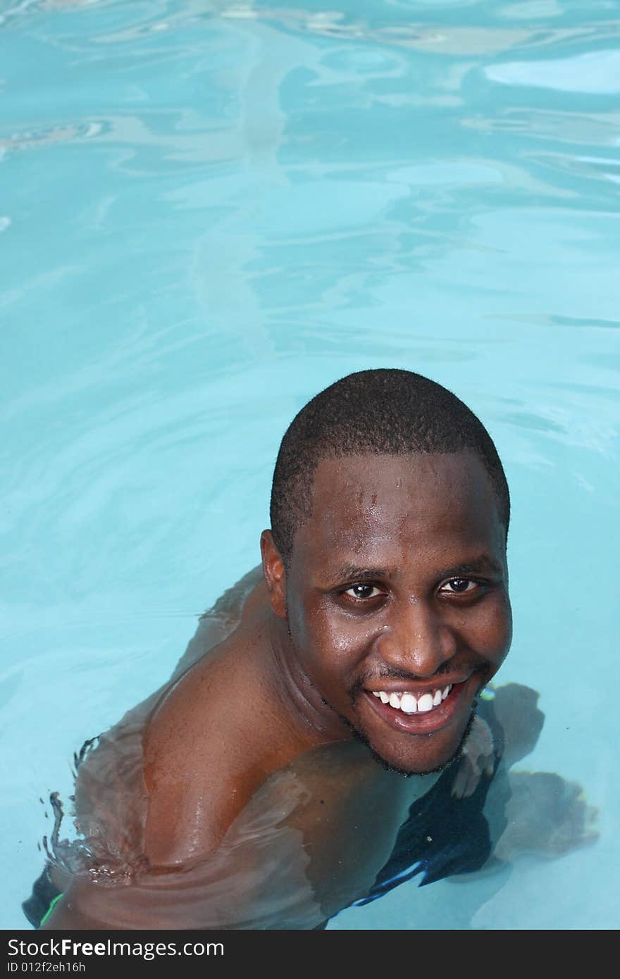 Man smiling while in a swimming pool. Man smiling while in a swimming pool