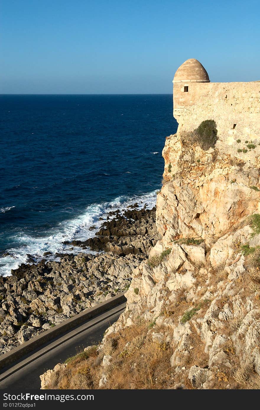 Walls and tower of the typical mediterranean fortress. Rethymno city. Crete island. Greece. Walls and tower of the typical mediterranean fortress. Rethymno city. Crete island. Greece.