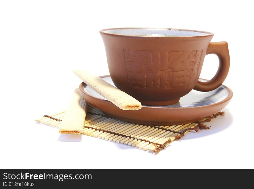 Ceramic cup and cookies isolated on white