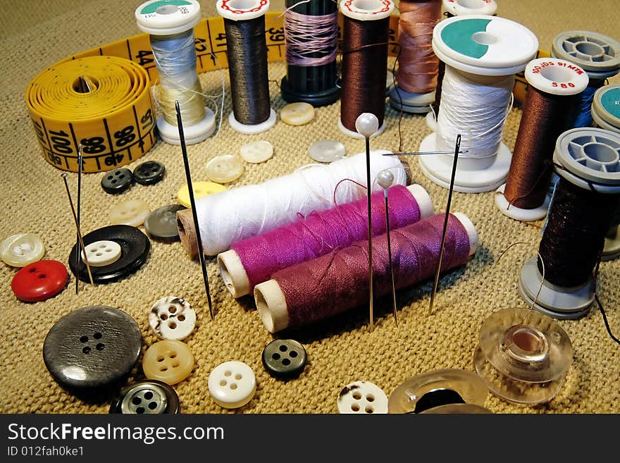 Several sewing material spreaded over the table. Several sewing material spreaded over the table.