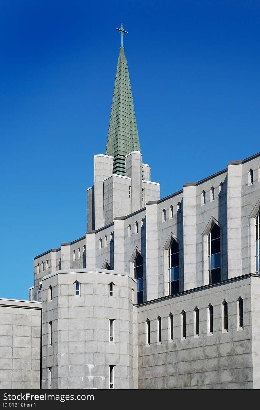 University stone gothic building with green gable. University stone gothic building with green gable