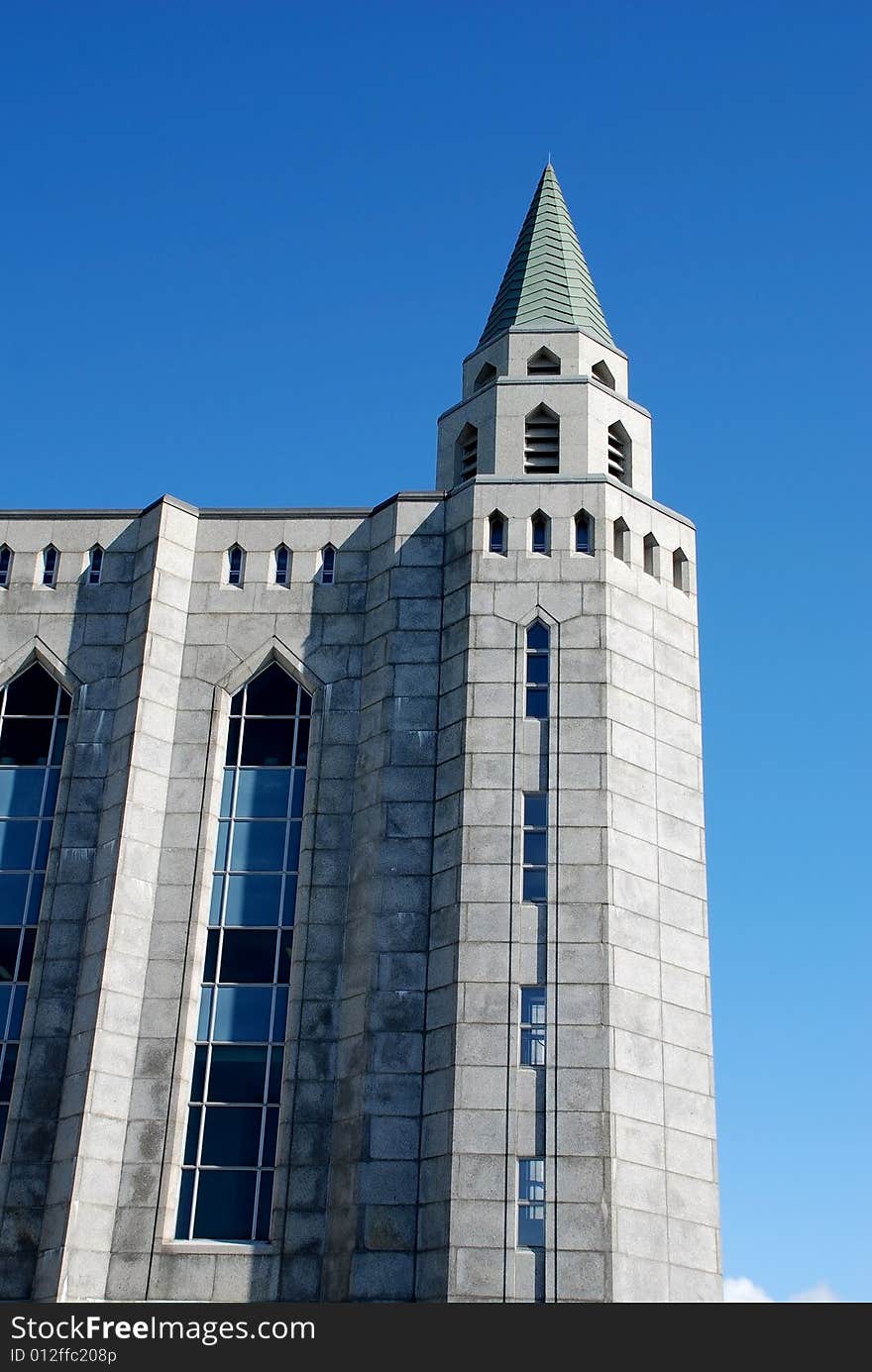 University stone gothic building with green gable. University stone gothic building with green gable