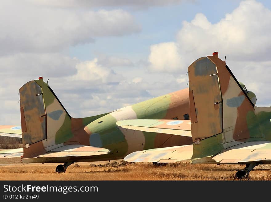 Detail of the tail sections on two old camoflaged aircraft. Detail of the tail sections on two old camoflaged aircraft