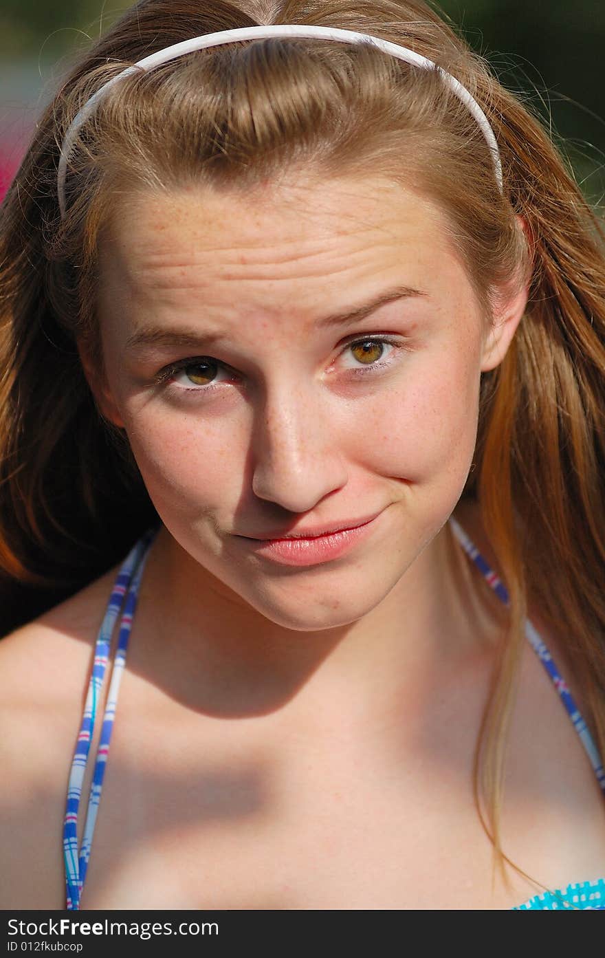 Teenager with headband and doubtful expression. Teenager with headband and doubtful expression.