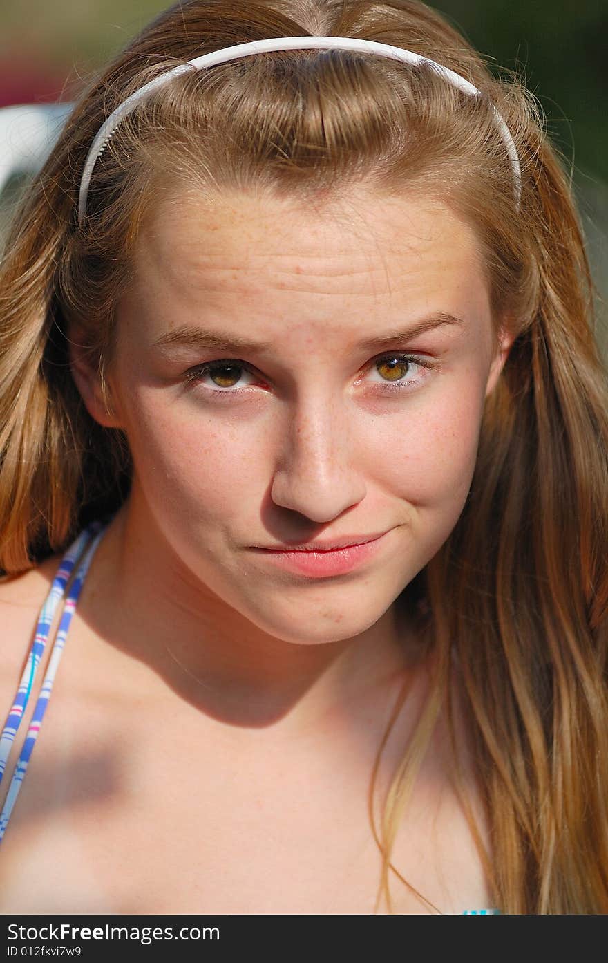 Teenager with headband and doubtful expression. Teenager with headband and doubtful expression.