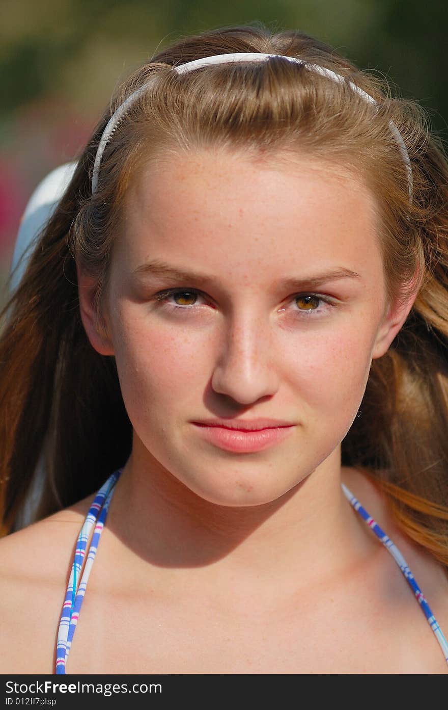 Teenager with headband and bathing suit before afternoon swim.