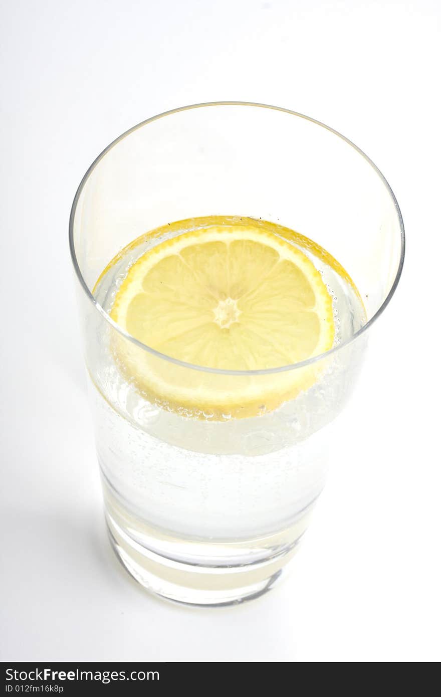 Glass of sparkling water with a lemon