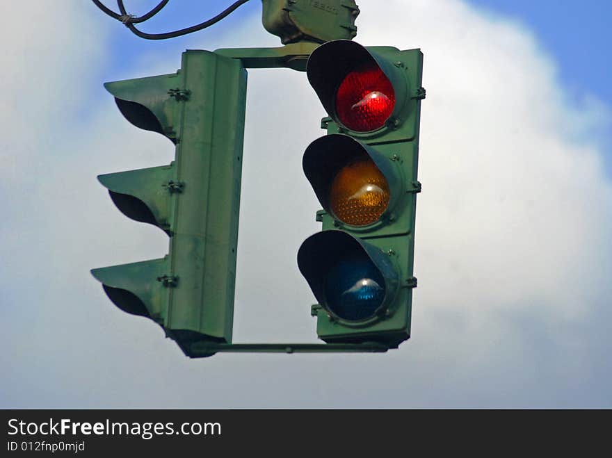 Traffic light gleaming red amonst the skyscape. Traffic light gleaming red amonst the skyscape.