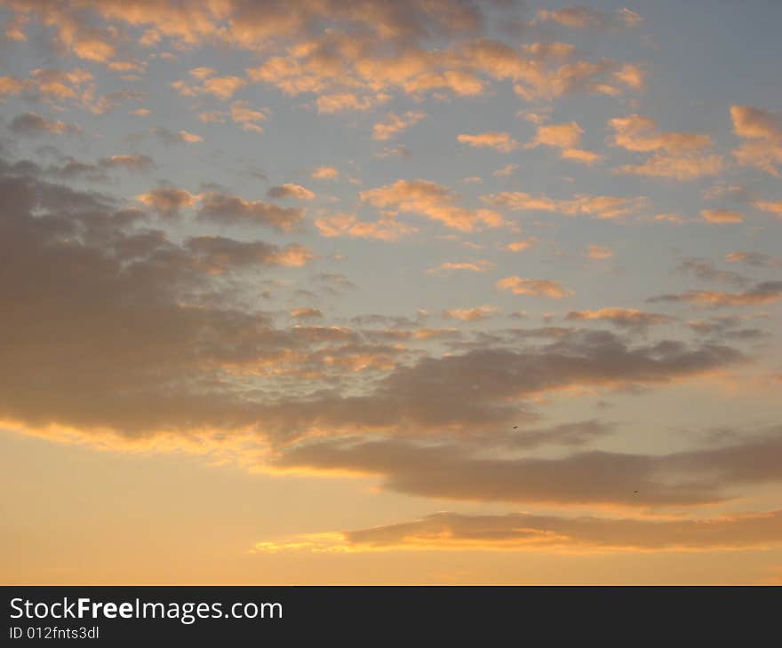 Sunrise above Kamchatcka.Gold clouds.