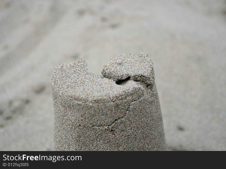 A crack in a sand pillar at the ocean.