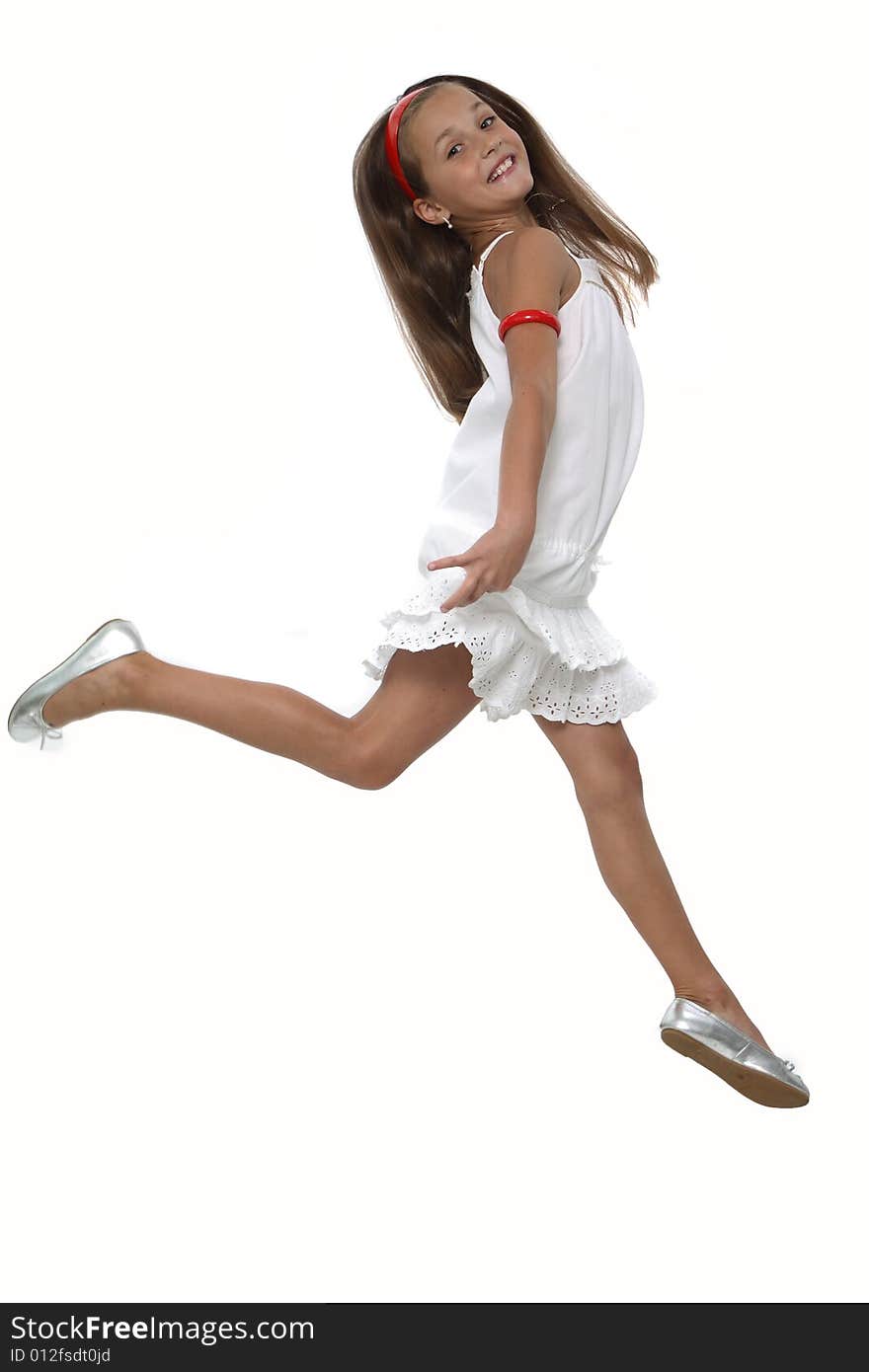 The girl in a white dress cheerfully runs. The girl in a white dress cheerfully runs