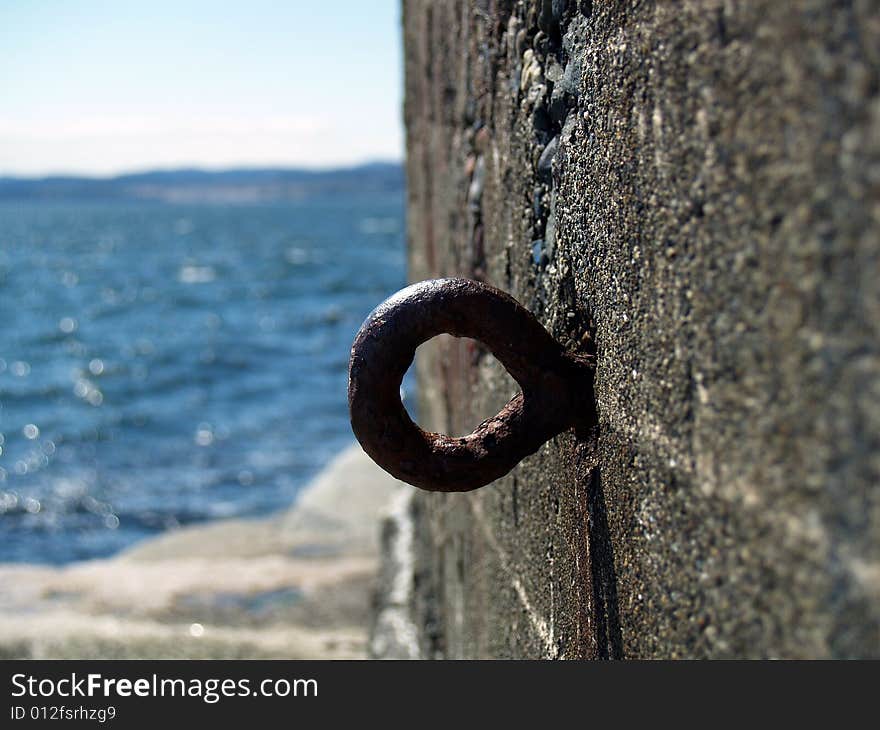 A hook on the side of a cement wall. A hook on the side of a cement wall.