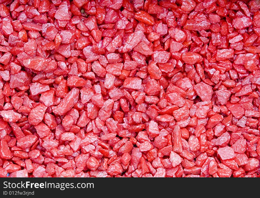 Red small textured stones background