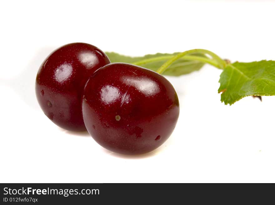 Isolated red cherries with leaves