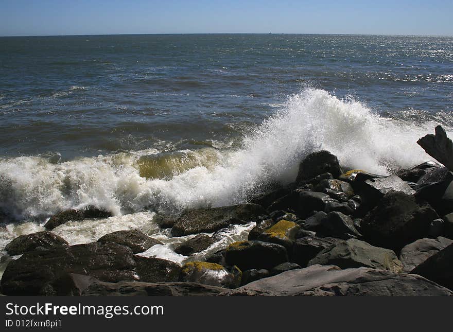 Ocean waves crashing in the rocks of the jetty near Ocean Shores Washington. Ocean waves crashing in the rocks of the jetty near Ocean Shores Washington.