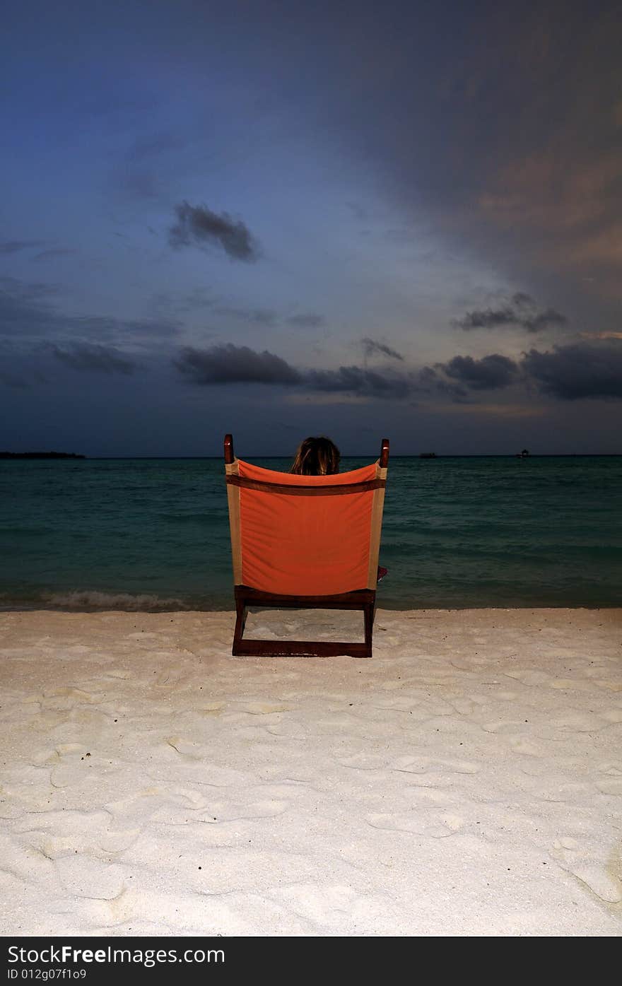 Nice vacation picture with woman sitting on a lounger. Nice vacation picture with woman sitting on a lounger