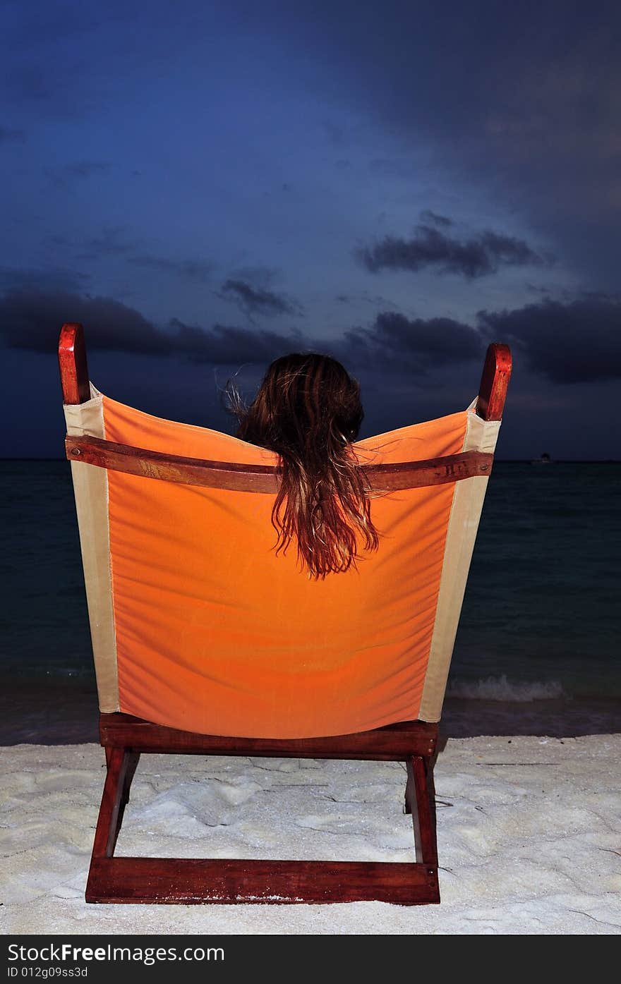 Nice vacation picture with woman sitting on a lounger. Nice vacation picture with woman sitting on a lounger