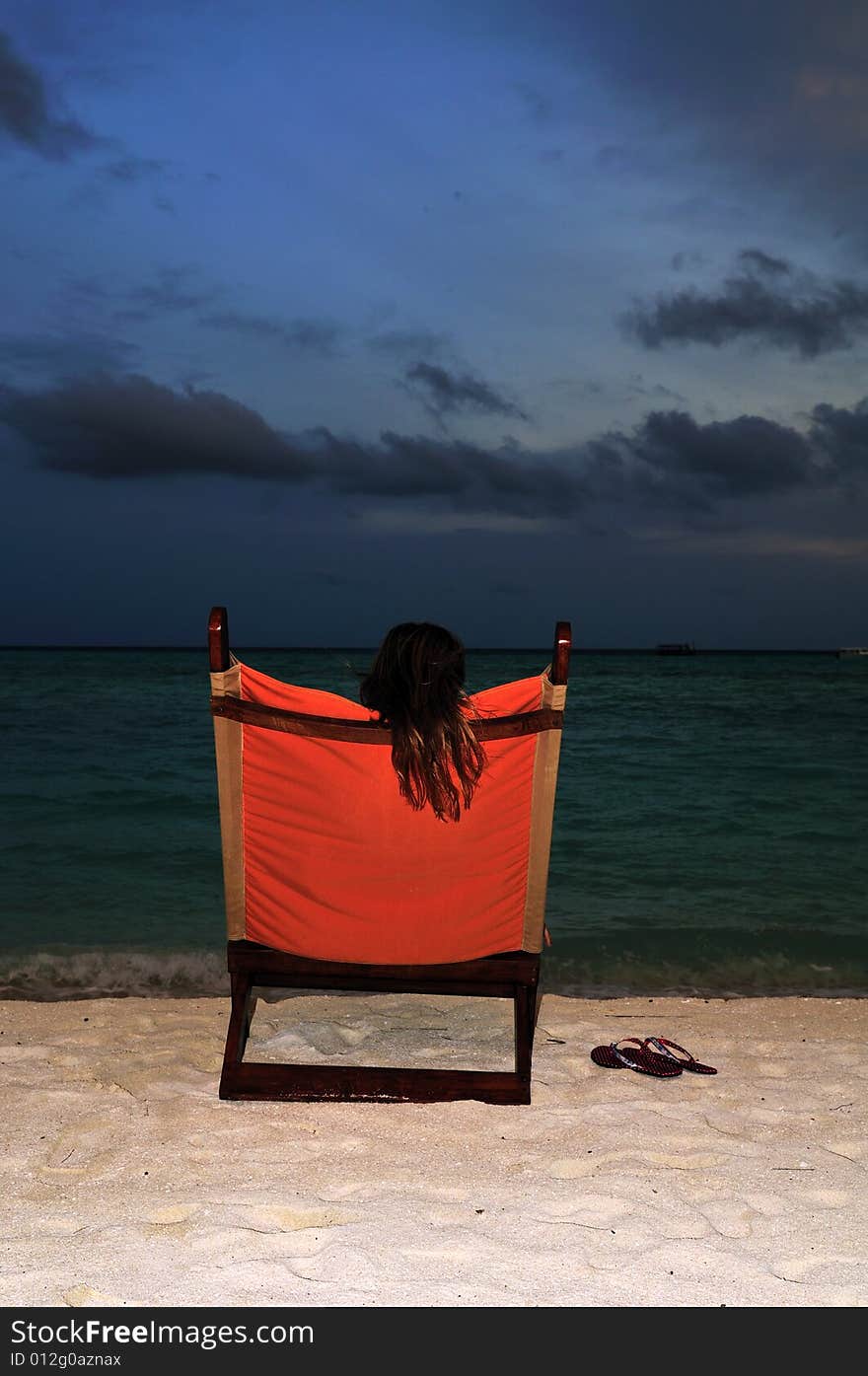 Nice vacation picture with woman sitting on a lounger. Nice vacation picture with woman sitting on a lounger