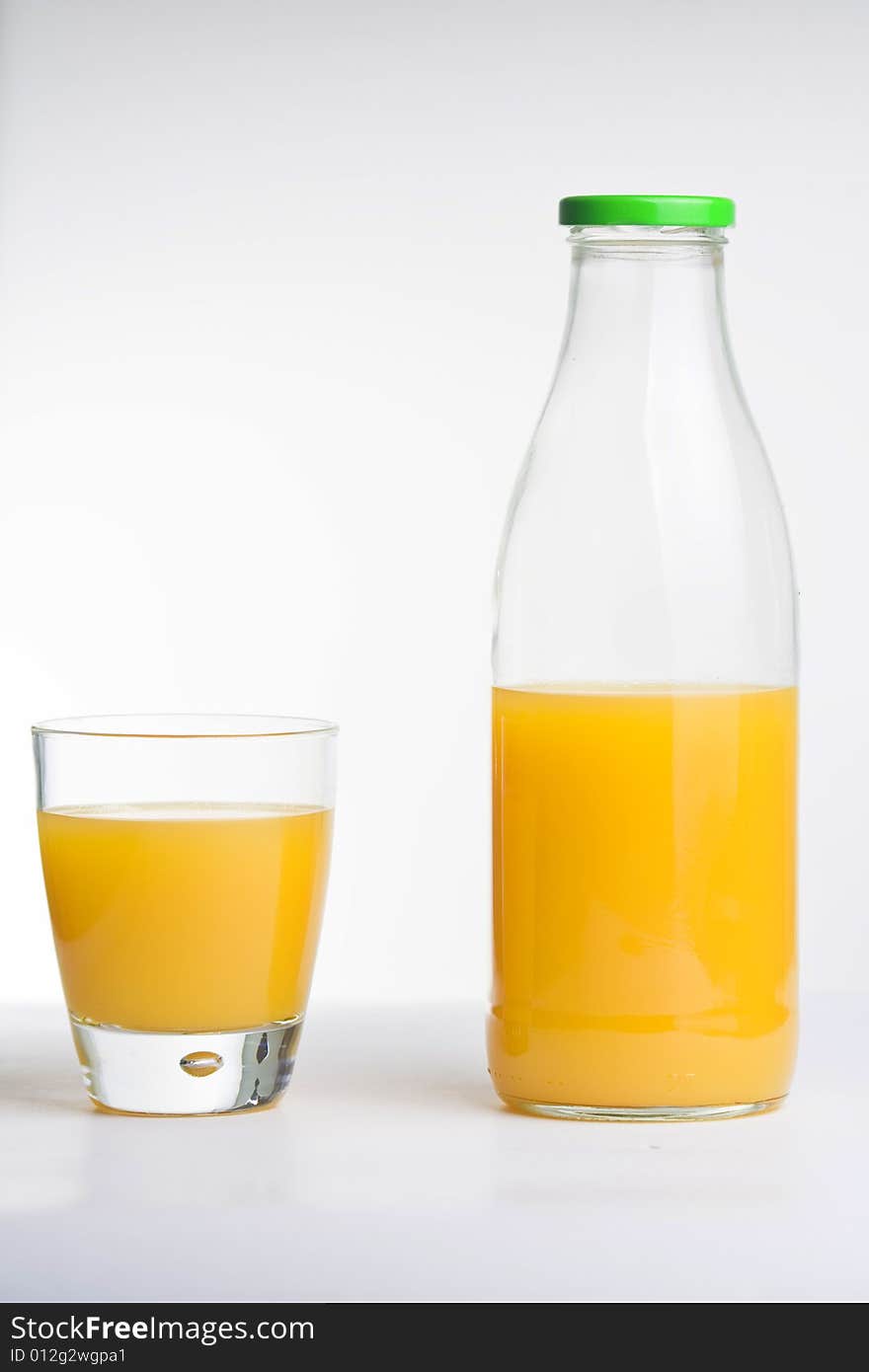 Orange juice, glass and bottle isolated over white