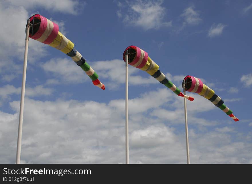 Coloured flags against the blue cloudy sky