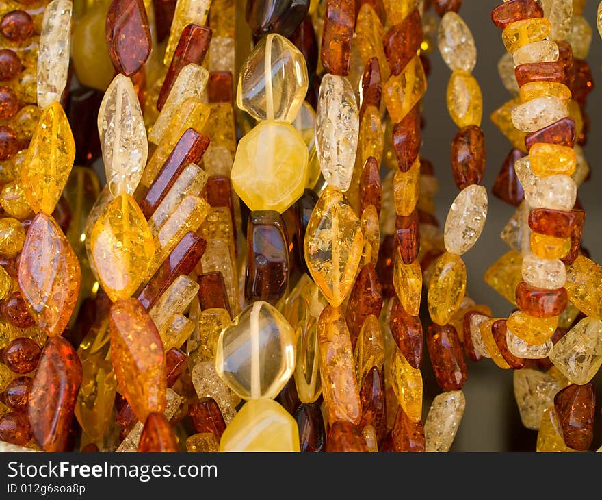 Close-up of different colored bijouterie from amber that can be use as texture or background