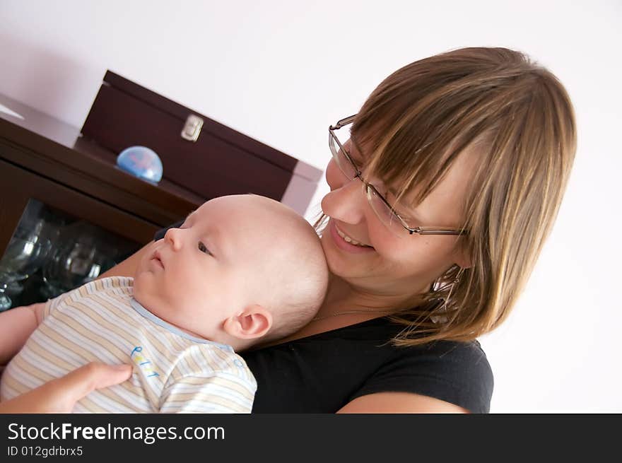 Happy mother with baby in her arms. Happy mother with baby in her arms