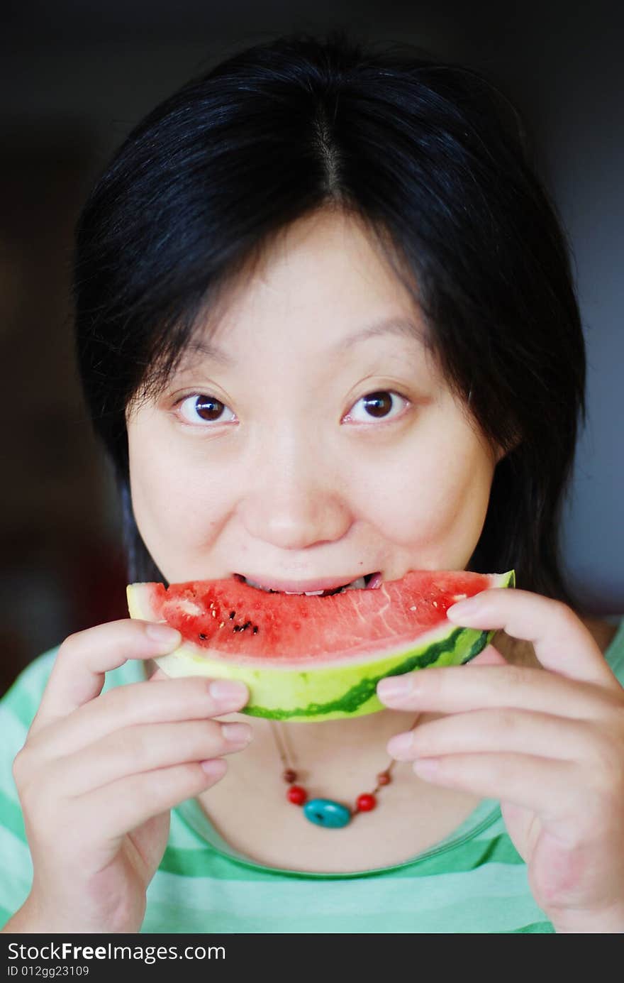 A girl eat watermelon in her home