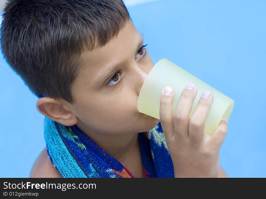 Cute young boy drink juice