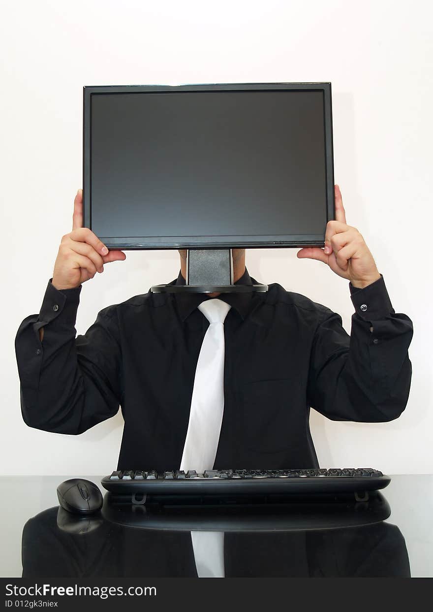 Businessman sitting on the desk, holding a computer monitor in hands. Businessman sitting on the desk, holding a computer monitor in hands