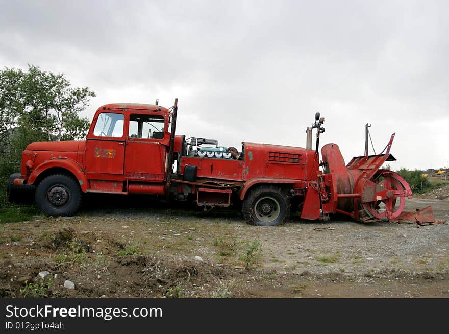 Old red lorry from the fifties with rotary snow cutter. Double cabin and three steering wheels. Old red lorry from the fifties with rotary snow cutter. Double cabin and three steering wheels.