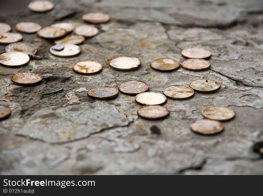 Old rusty coins on stones. Old rusty coins on stones