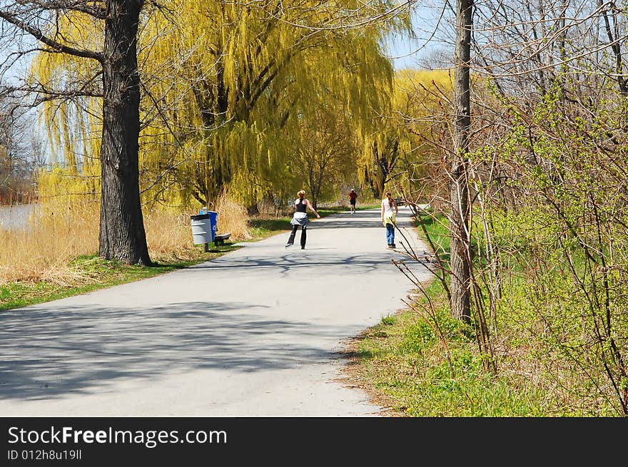 Nice sunny spring day and two girls on roller plates. Nice sunny spring day and two girls on roller plates.