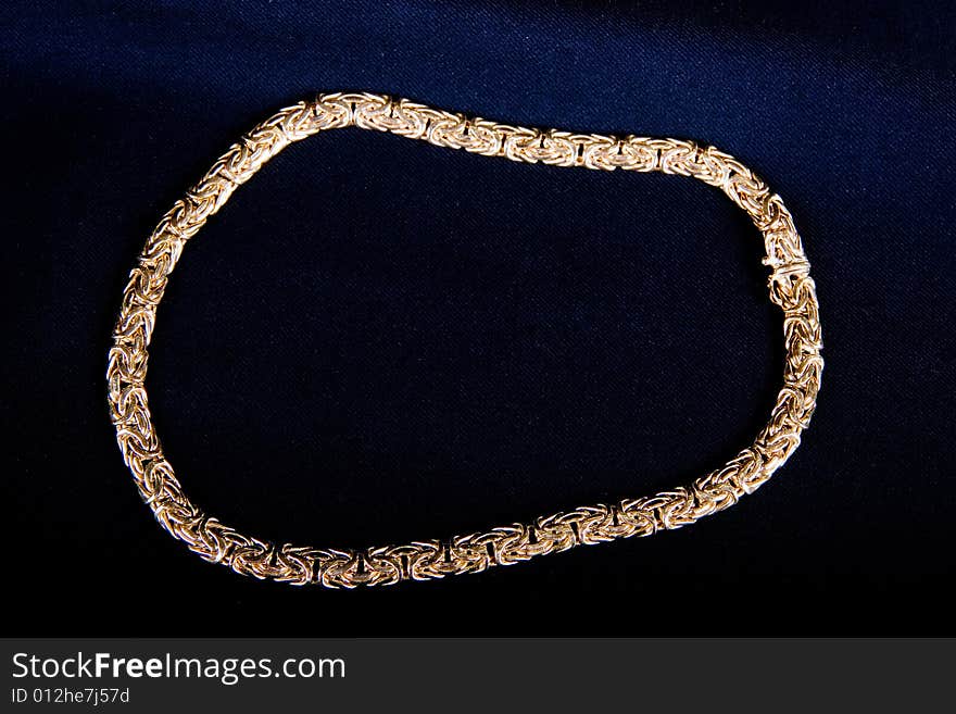 A necklace of a gold band on black background. A necklace of a gold band on black background