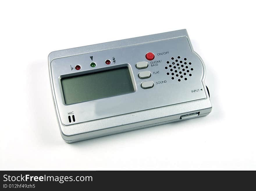 A photograph of a guitar tuner against a white background