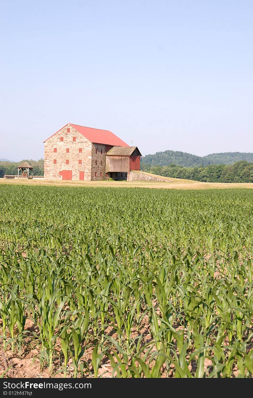 Country Barn with old well next to it.