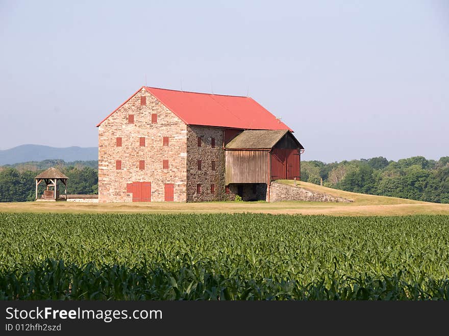 Country Barn with old well next to it.