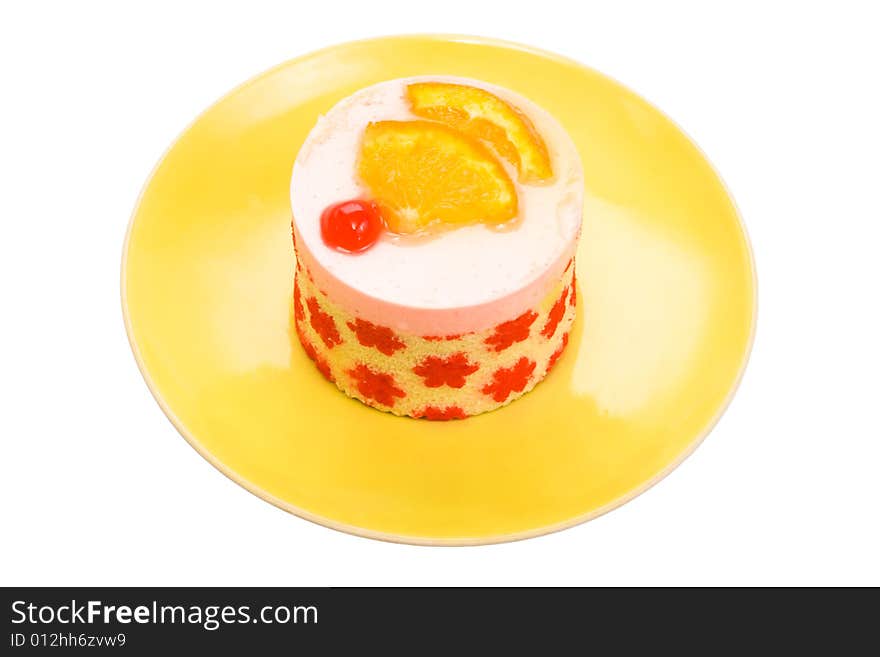 Cake with a cherry and an orange on a yellow plate