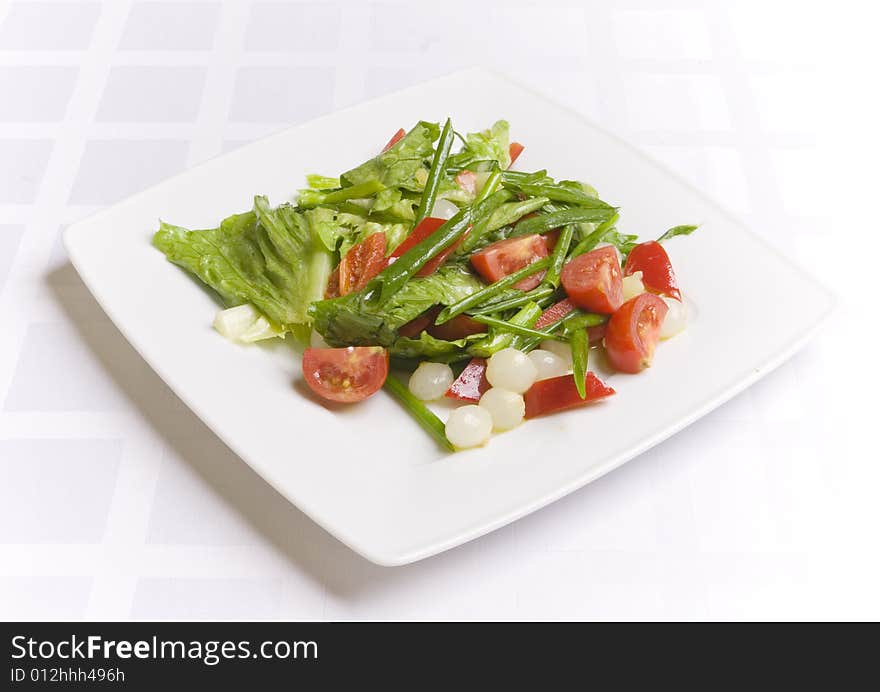 Salad with vegetables on white plate