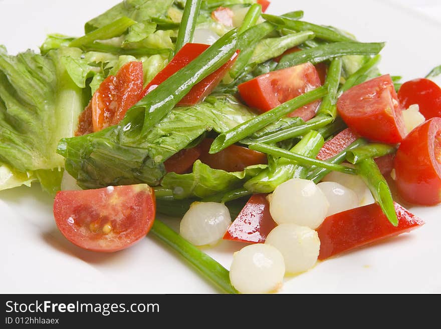 Salad with vegetables on white plate