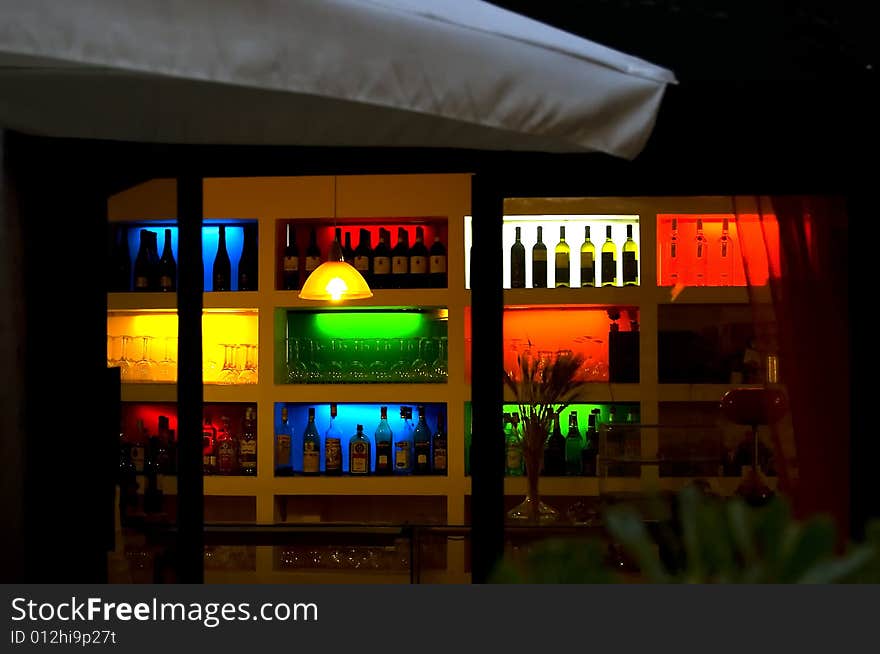 View of a set of illuminated bottles in a  bar of Via di Santa Cecilia, trastevere,  Roma, italy. View of a set of illuminated bottles in a  bar of Via di Santa Cecilia, trastevere,  Roma, italy