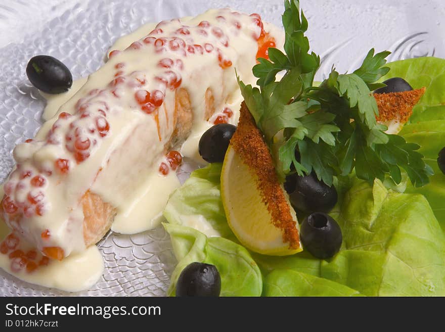 Fish decoratet with salad on the plate. Fish decoratet with salad on the plate