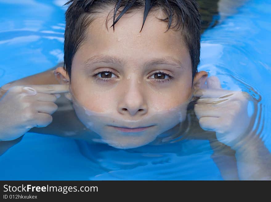 Portrait of young boy in pool