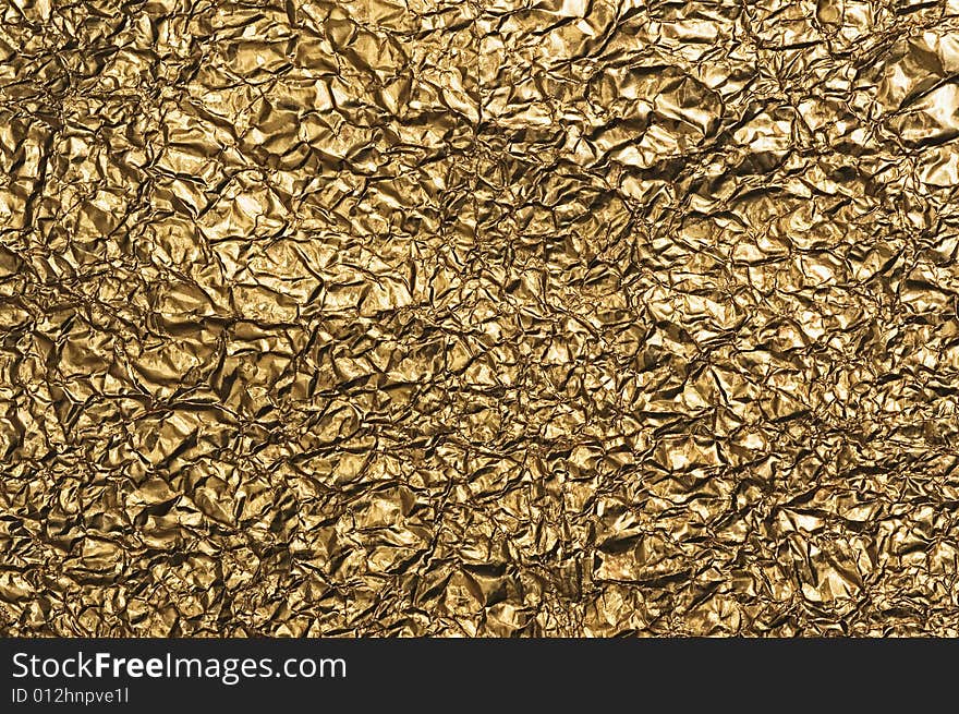 Gold metallic crumpled paper texture for background