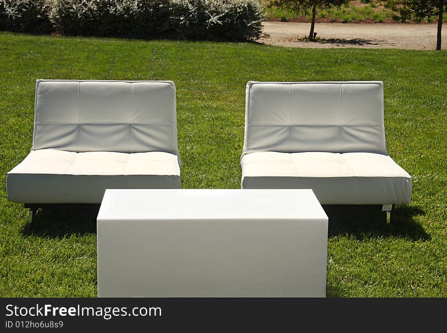 White chairs set up outside on lawn. White chairs set up outside on lawn