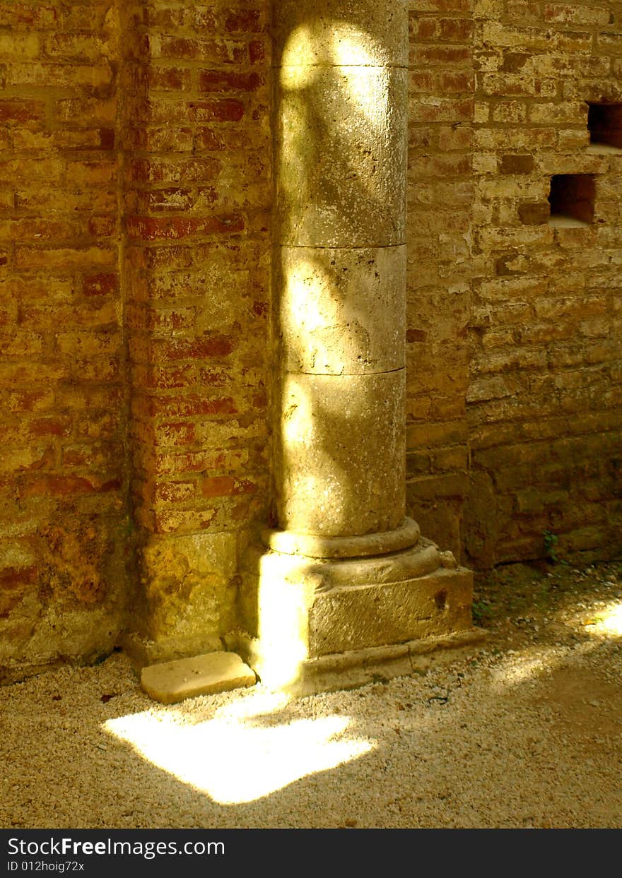 A suggestive shot of the light that plays on an ancient column in San Galgano abbey. A suggestive shot of the light that plays on an ancient column in San Galgano abbey