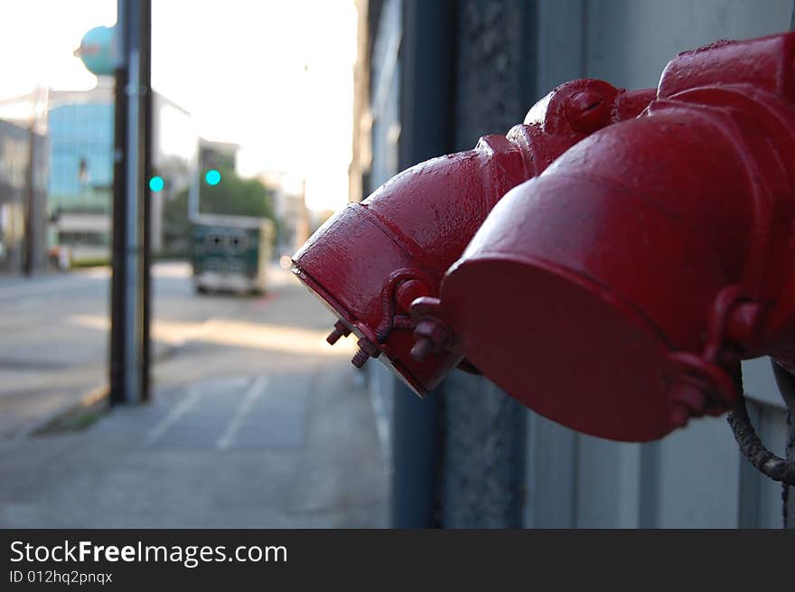 Red painted pipe in the city street. Red painted pipe in the city street